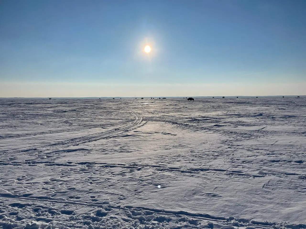 Frozen Good Spirit Lake with ice fishing shacks, 2024