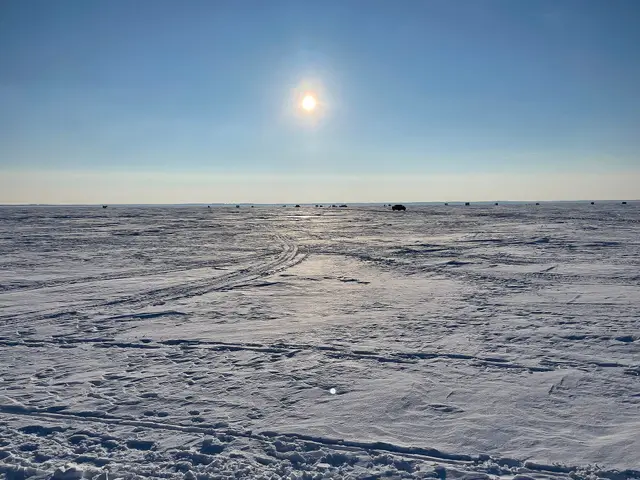 Frozen Good Spirit Lake with ice fishing shacks