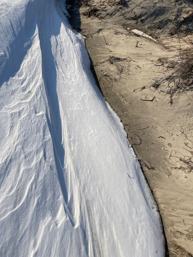 Snow drift and sand at the beach